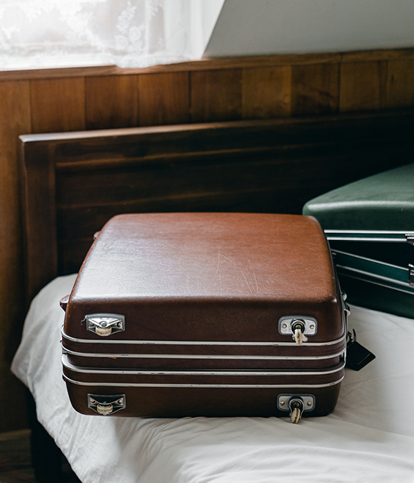 A suitcase resting on a bed
